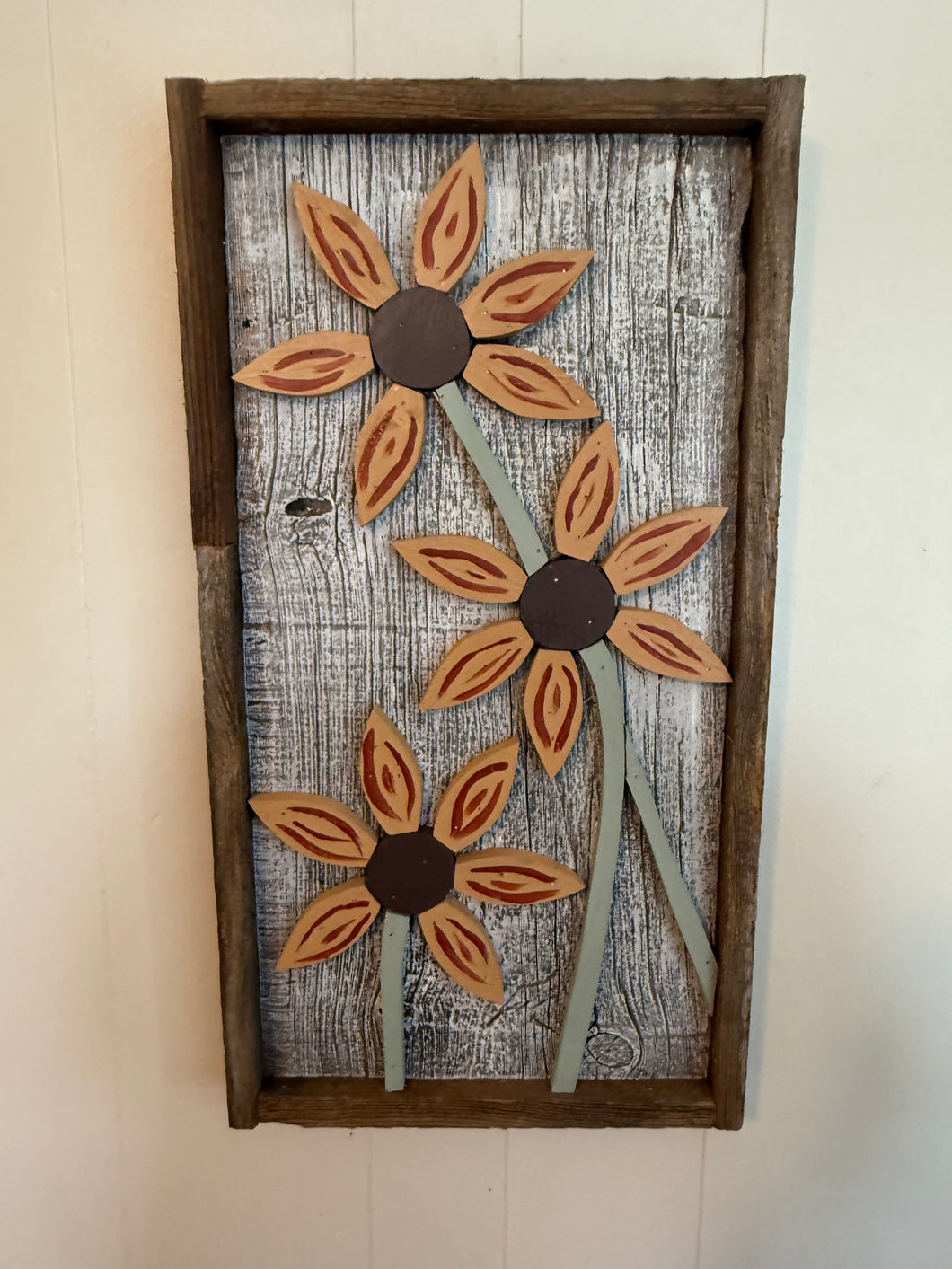 Triple sunflower on century old barnboard frame .
